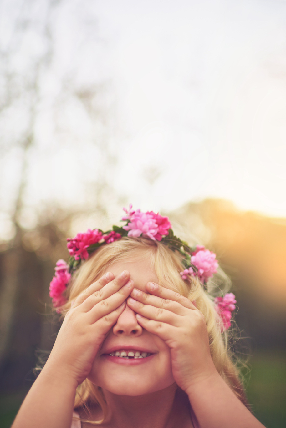 Shot of a cheerful little girl with her hands on her eyes playing hide and seek outside in nature